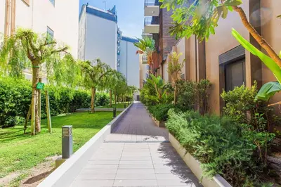 a walkway in a building with trees and plants at Nice SuiteMarie Carre d'or in Nice