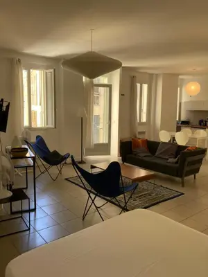 a living room with chairs and a couch at L'Appartement Bleu in Nice