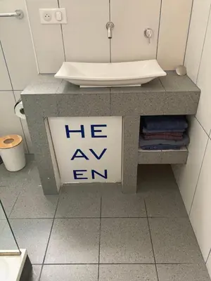 a counter with a sink and a sign on it at L'Appartement Bleu in Nice