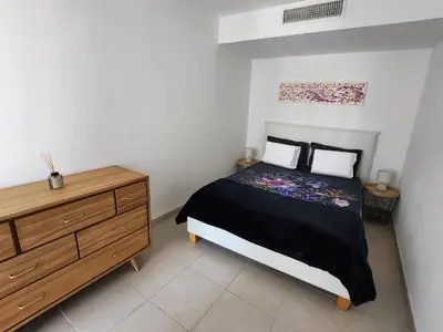 a bedroom with a bed and a wooden dresser at Appartement Nice Carré d Or in Nice