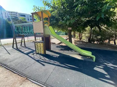 a playground with a slide in a park at Superbe appartement de 3p pieces dans residence avec piscine et climatisation in Nice