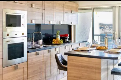 a kitchen with a counter with a sink and a microwave at Magnificent 3 Rooms-Sea View-Terrace-Pool in Nice