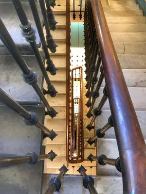 a spiral staircase with wooden railings and a wooden floor at Suite Offenbach FSHH in Nice