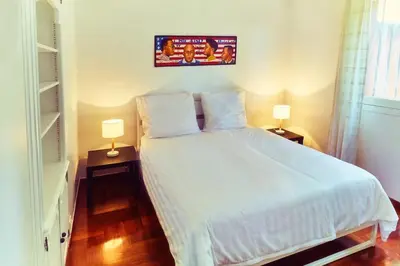 a bedroom with a white bed and two lamps at Best View ever! in Èze