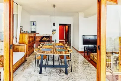 a dining room with a table with chairs and a television at Best View ever! in Èze
