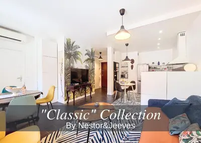a living room with a couch and a kitchen at Nestor&Jeeves - ESCAPADE - Central - Near Beach in Nice
