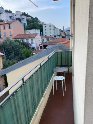 a balcony with a table and chairs on it at Appartement Flores in Nice