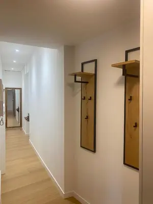 a hallway with wooden shelves and a mirror on a wall at Historic Bright and Beautiful Apartment in Old Nice with Castle Hill View in Nice