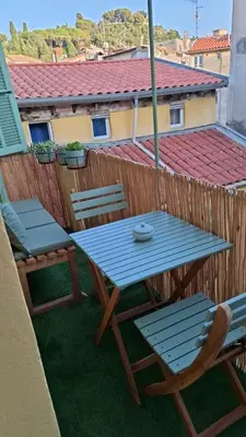 a blue table and chairs on a balcony at Historic Bright and Beautiful Apartment in Old Nice with Castle Hill View in Nice