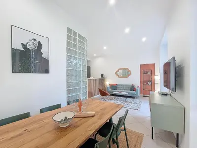 a kitchen and dining room with a wooden table at Nestor&Jeeves - BEL AIR - City Center - Modern in Nice