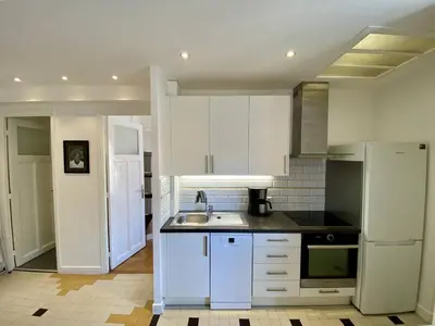a kitchen with white cabinets and a sink at Nice Hypercentre- Joli 2Pièces in Nice