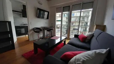 a living room with a couch and a table at Very Nice Apartment in Nice