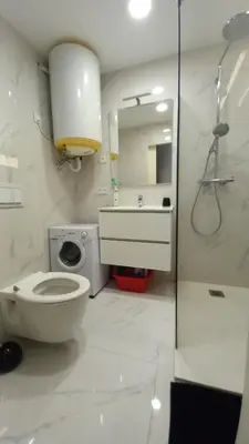 a bathroom with a toilet and a sink and a mirror at Very Nice Apartment in Nice