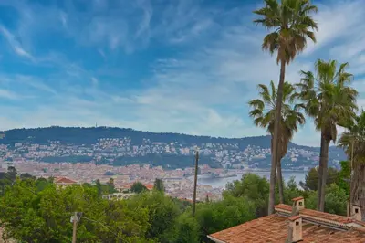 a view of a city with palm trees at Unique appartement à Nice vue mer imprenable in Nice