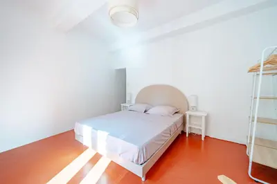 a white bedroom with a bed and a ladder at Charmant Appartement 2P au Cœur du Vieux Nice in Nice