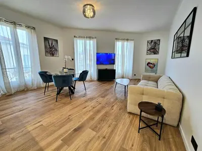 a living room with a couch and a table at Très bel appartement Nice centre in Nice