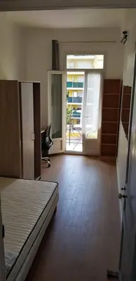 an empty room with a bed and a desk in it at Appartement lumineux in Nice
