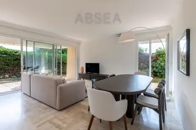 a living room with a table and chairs at Nice Absea Fabron 2 in Nice