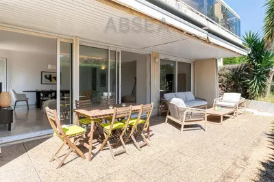 a patio with a wooden table and chairs at Nice Absea Fabron 2 in Nice