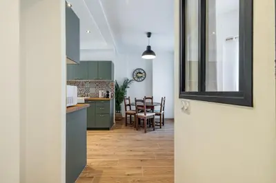 a kitchen and dining room with a table and chairs at Large & Quiet 1 Bdr Downtown in Nice