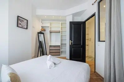 a bedroom with a white bed and a closet at Large & Quiet 1 Bdr Downtown in Nice