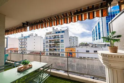 a balcony with a table and a view of a city at Large 2 Bdr Close to the Beach Balcony & Garage in Nice