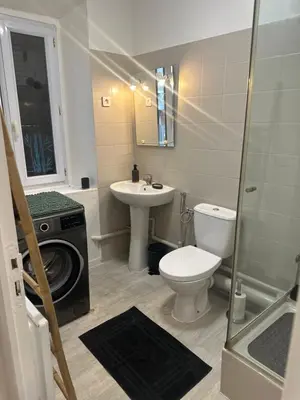 a bathroom with a toilet sink and a washing machine at Carras in Nice