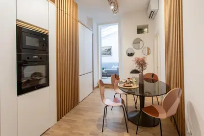a kitchen and dining room with a table and chairs at #51 1BDR Massena,central 5 min to the beach AC in Nice