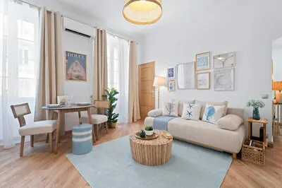 a living room with a couch and a table at Nice Renting - 5bFRANCE - Luxurious Apartment Place Massena Promenade des Anglais in Nice