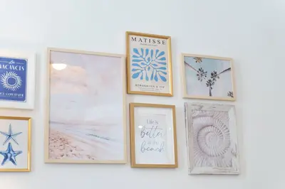 a group of framed pictures on a wall at Nice Renting - 5bFRANCE - Luxurious Apartment Place Massena Promenade des Anglais in Nice