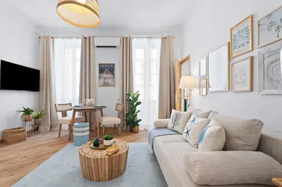a living room with a couch and a table at Nice Renting - 5bFRANCE - Luxurious Apartment Place Massena Promenade des Anglais in Nice