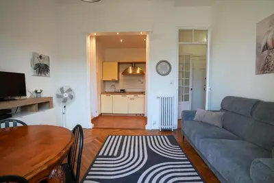 a living room with a couch and a table at Coeur de Nice - Plage et Centre in Nice