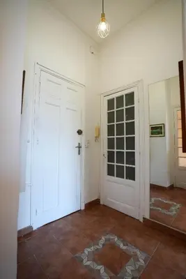 an empty room with a white door and a tile floor at Coeur de Nice - Plage et Centre in Nice