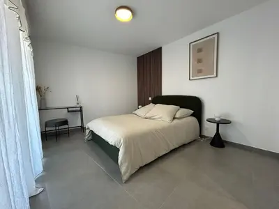a bedroom with a bed and a table and a desk at Sea Breeze By Avecoeur in Nice