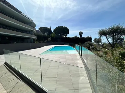 a glass walkway leading to a swimming pool at Sea Breeze By Avecoeur in Nice