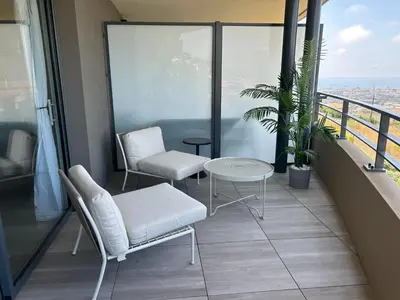 a balcony with two chairs and a table at Sea Breeze By Avecoeur in Nice