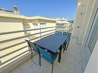 a blue table and chairs on a balcony at Sea Front Penthouse Cote d Azur in Nice