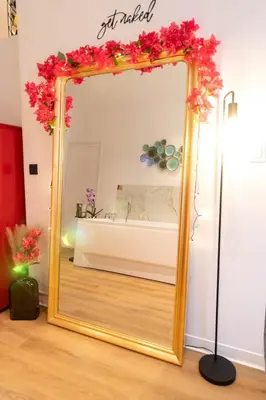 a mirror with a floral wreath on it in a room at Riviera Bliss in Nice