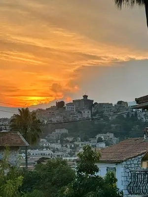 a sunset over a city with a castle on a hill at Dolce Vita, Spa, Cagnes Sur Mer in Cagnes-sur-Mer