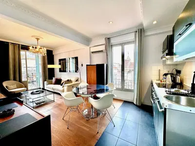 a kitchen and living room with a table and chairs at ApartHotel Riviera - LE PETIT BALCON DE L'OPERA - Old Town Promenade des Anglais in Nice