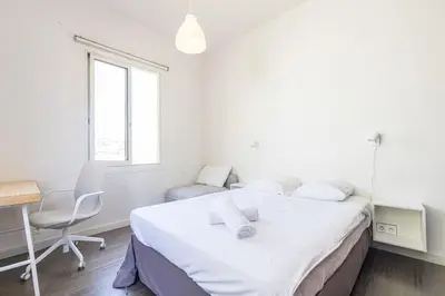 a white bedroom with a bed and a desk and a chair at PENTHOUSE 2Bedroms 6pax- Views 45m2 Terrace in Nice