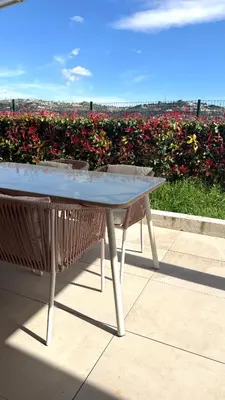 a couch with pillows and a dog sitting on it at Superbe appartement lumineux en rez de jardin in Saint-Laurent-du-Var