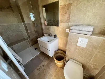 a white bedroom with a large bed with a window at Entre les citronniers et la mer in Èze