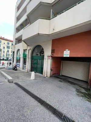 a building with a parking lot in front of it at La Terrasse de Palais des Arts in Nice