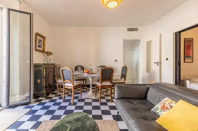 a living room with a couch and a table and chairs at Appartement de charme centre vieux village in Villefranche-sur-Mer