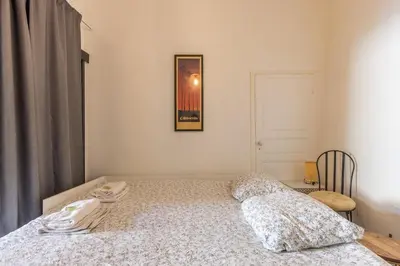 a bedroom with a bed and a picture on the wall at Appartement de charme centre vieux village in Villefranche-sur-Mer
