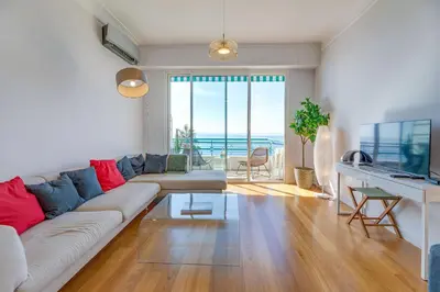 a living room with a couch and a table at LE 3 PROMENADE AP4424 By Riviera Holiday Homes in Nice