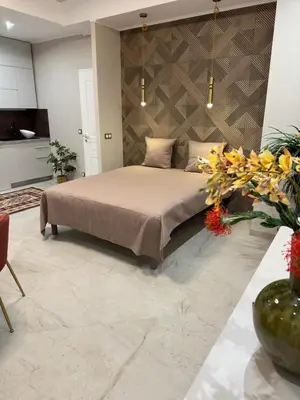 a bedroom with a bed and flowers in a room at Extraordinaire grand studio au centre 6 minutes à pied de la plage et l'hôtel Negresco in Nice