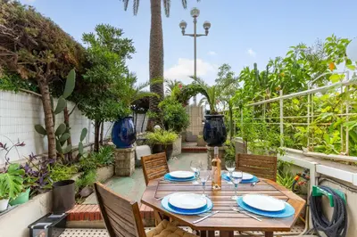 a wooden table and chairs on a patio at Happyfew La Promenade 53 in Nice