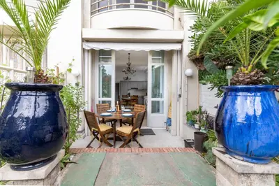 two large blue vases on a patio with a table at Happyfew La Promenade 53 in Nice